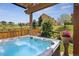 Inviting backyard featuring a private hot tub under a pergola with views of the surrounding neighborhood at 4077 Forever Cir, Castle Rock, CO 80109