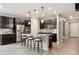 Open kitchen with stainless appliances, dark cabinetry, granite countertops, and seating at the island at 4077 Forever Cir, Castle Rock, CO 80109