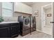 Laundry room with side-by-side washer and dryer, counter and sink, and hanging cabinets at 4077 Forever Cir, Castle Rock, CO 80109