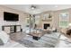 Bright living room with fireplace, stylish furniture, and sliding doors to outdoor hot tub at 4077 Forever Cir, Castle Rock, CO 80109