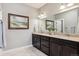 Main bath with double vanity, granite countertops, tile floor, and framed artwork at 4077 Forever Cir, Castle Rock, CO 80109