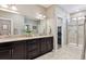 Main bathroom showcasing double vanity, granite countertops, and large glass shower at 4077 Forever Cir, Castle Rock, CO 80109