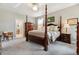 Spacious main bedroom with a four poster bed, neutral colors and carpeted floors at 4077 Forever Cir, Castle Rock, CO 80109