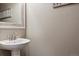 Close up of a powder room with a pedestal sink, attractive faucet and neutral colors at 4077 Forever Cir, Castle Rock, CO 80109
