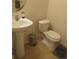 Powder bathroom featuring a pedestal sink, toilet, and neutral tones at 573 Alton Way # B, Denver, CO 80230