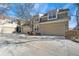 Home exterior showing a three car garage, neutral paint, flag, and mature landscaping at 4545 S Monaco St # 119, Denver, CO 80237