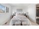 Cozy bedroom featuring a plush bed with neutral bedding and soft, natural light at 10275 Quail St, Westminster, CO 80021