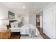 Cozy bedroom features wood floors, ensuite bathroom, and closet for optimal comfort and convenience at 10275 Quail St, Westminster, CO 80021
