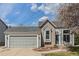 Charming home with a two-car garage, blue door, and a beautiful flower garden at 10275 Quail St, Westminster, CO 80021
