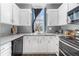 Well-lit kitchen with white cabinets, grey countertops, and modern appliances at 10275 Quail St, Westminster, CO 80021
