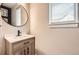 Small bathroom with a modern vanity and round mirror at 2932 Low Meadow Blvd, Castle Rock, CO 80109