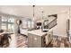 Open concept kitchen with a large island, white cabinets and stainless steel appliances at 2932 Low Meadow Blvd, Castle Rock, CO 80109