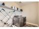 Bright laundry room with washer, dryer, and storage shelves at 2932 Low Meadow Blvd, Castle Rock, CO 80109