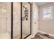 Walk-in shower with marble tile and built-in shelving at 2932 Low Meadow Blvd, Castle Rock, CO 80109