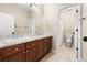 Bathroom featuring a double vanity with granite countertops and tiled floors at 14310 Inca St, Westminster, CO 80023