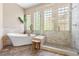 This elegant bathroom includes a soaking tub, glass-enclosed shower, and stylish tile work at 14310 Inca St, Westminster, CO 80023