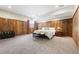 Rustic bedroom with wood paneling, a plush bed, and a cozy atmosphere at 14310 Inca St, Westminster, CO 80023