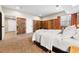 Bedroom featuring wood paneling, neutral carpet, and bright windows at 14310 Inca St, Westminster, CO 80023
