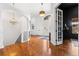 Bright foyer boasts hardwood floors, a chandelier, and an archway leading to the staircase at 14310 Inca St, Westminster, CO 80023
