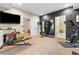 Home gym featuring a variety of workout equipment, mirrors, and access to a bathroom at 14310 Inca St, Westminster, CO 80023
