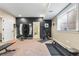 Spacious home gym with exercise equipment and a dark accent wall at 14310 Inca St, Westminster, CO 80023