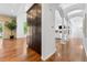 Hallway featuring hardwood floors, pillars, and a built-in cabinet at 14310 Inca St, Westminster, CO 80023