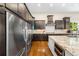 This kitchen features stainless steel appliances, granite countertops, and dark wood cabinets at 14310 Inca St, Westminster, CO 80023
