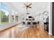Bright living room featuring large windows, a fireplace, and hardwood floors at 14310 Inca St, Westminster, CO 80023