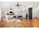 Open concept living room with fireplace, hardwood floors, and elegant architectural details at 14310 Inca St, Westminster, CO 80023