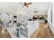 Bright, open living space featuring white sectional sofa, hardwood floors, and stylish decor throughout at 14310 Inca St, Westminster, CO 80023