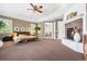 The spacious main bedroom includes a fireplace, ceiling fan, and access to the ensuite bath at 14310 Inca St, Westminster, CO 80023