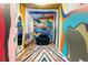 Whimsical playroom featuring vibrant psychedelic wall art, a cozy seat, and a disco ball at 14310 Inca St, Westminster, CO 80023