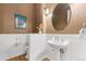 Classic powder room with pedestal sink, wainscoting, and hardwood floors at 14310 Inca St, Westminster, CO 80023