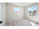 Bedroom with carpet, bright neutral walls, and two windows with neighborhood views at 21142 E 63Rd Dr, Aurora, CO 80019