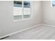 Bedroom showcasing neutral walls and large window, filled with natural light at 21142 E 63Rd Dr, Aurora, CO 80019