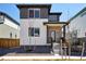 Charming two-story home featuring a modern design with a purple front door and well-maintained landscaping at 21142 E 63Rd Dr, Aurora, CO 80019