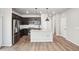 Modern kitchen with stainless steel appliances, a central island, and dark cabinetry at 21142 E 63Rd Dr, Aurora, CO 80019