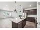 Open kitchen with a center island, stainless steel appliances, and seamless integration with the living area at 21142 E 63Rd Dr, Aurora, CO 80019