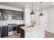 Stylish kitchen featuring a center island, stainless steel appliances, and modern fixtures at 21142 E 63Rd Dr, Aurora, CO 80019