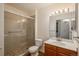 Bathroom featuring a glass-enclosed shower with tiled walls, a toilet, and a vanity with a sink at 8775 W Berry Ave # 101, Littleton, CO 80123