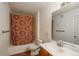 Full bathroom with a combined tub and shower, adorned with a patterned curtain and classic fixtures at 8775 W Berry Ave # 101, Littleton, CO 80123