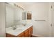 Bathroom with dual sinks, a large mirror, and modern lighting, providing a bright and functional space at 8775 W Berry Ave # 101, Littleton, CO 80123