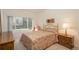 Charming bedroom with a large window providing natural light, decorated with a bed and matching nightstand at 8775 W Berry Ave # 101, Littleton, CO 80123