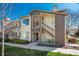Inviting two-story condo featuring neutral siding, a private entrance, and well-maintained landscaping at 8775 W Berry Ave # 101, Littleton, CO 80123