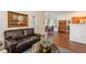 Open-concept living space flows into the dining area, featuring modern décor at 8775 W Berry Ave # 101, Littleton, CO 80123