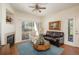 Bright living room features a fireplace, sliding glass doors, and cozy furnishings at 8775 W Berry Ave # 101, Littleton, CO 80123