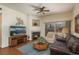 Comfortable living room with a fireplace, ceiling fan, and sliding glass doors for ample natural light at 8775 W Berry Ave # 101, Littleton, CO 80123