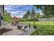 Relaxing backyard with string lights, a patio set, lush green lawn, and a fire pit area perfect for gatherings at 12020 W Alabama Pl, Lakewood, CO 80228