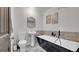 Elegant bathroom features a modern tub, pedestal sink, tiled walls, and sleek fixtures for a relaxing spa experience at 12020 W Alabama Pl, Lakewood, CO 80228