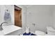Bathroom with a wood-look tiled shower, toilet, and vanity with white countertop at 12020 W Alabama Pl, Lakewood, CO 80228